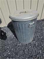 Galvanized trash can with grass seed