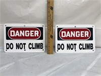 Pair of metal signs danger do not climb