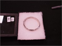 Laser-cut bangle marked 925, with safety