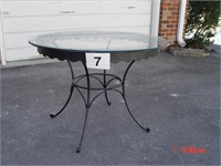 heavy scalloped table, iron legs, glass top