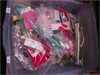 Container of Barbie and friends outfits,