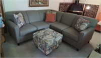 Sectional sofa with pillows and footstool
