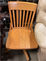 Wood  office chair, swivels and  on wheels