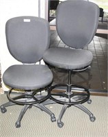 Two bar height rolling office chairs black