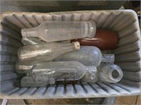 Plastic bucket of vintage bottles