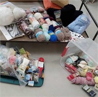 Lot of yarn and rug hooking in clear tub