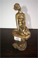 Brass sculpture of a nude female kneeling