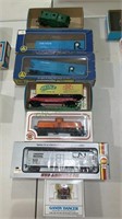 Nine toy model trains in the boxes. Includes a