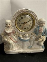 Porcelain man and woman clock