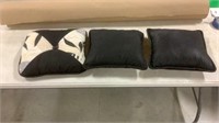 A pair of black pillows with an accent pillow