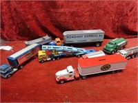 Assorted toy diecast trucks and trailers.