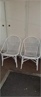 2 white rattan chairs