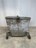 Vintage metal mop bucket on casters