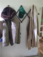 Coat rack with coats unknown sizes and a cap