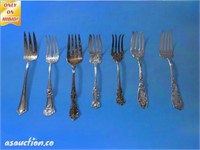 Seven silver plated serving forks