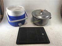 A Cooler, Pot, and Cast Iron Grill