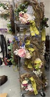 4 floral wreaths with green ribbon.