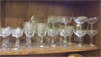 Shelf lot with 36 glasses and a glass drink