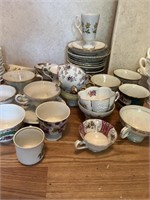 Large selection of tea, cups, and saucers. Find