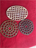 Two cast-iron trivets in aluminum trivet one