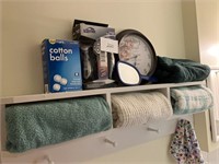 new elactric shaver with bathroom towels on shelf