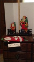 Wooden Santas and believe sign