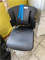 4 black stackable chairs