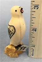 3" scrimmed white ivory bird on a piece of fossili