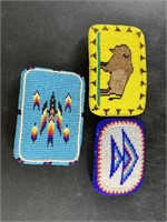 Three intricately beaded belt buckles in Native Am