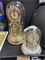 Pair of globe carousel clocks.