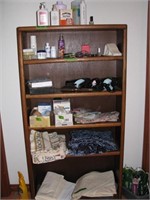 Bookcase with misc bathroom contents