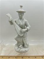 Musician figurine has had hand reattached in the