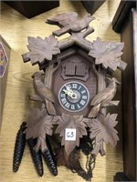 Cuckoo clock has pendulum and weights