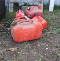 Five gas cans, some complete, some missing