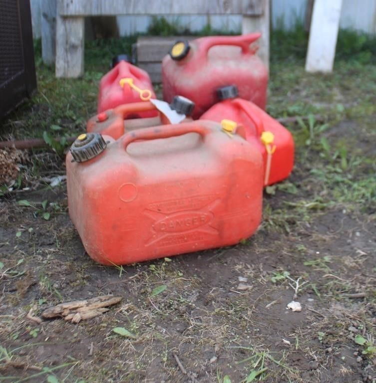 Five gas cans, some complete, some missing