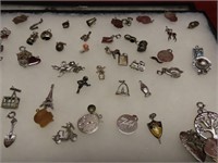Showcase of Vintage mostly sterling silver charms.