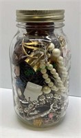 Mason jar full of costume jewelry    1915