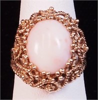 A yellow gold ring marked 14K with pink coral