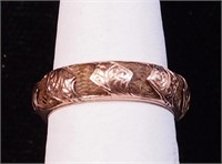 A rose gold ring, unmarked but tested, with hair