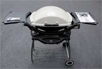 Weber portable LP gas grill with rolling cart