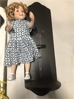 Shirley Temple porcelain doll on wall stand