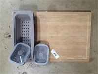 Wooden cutting board with grey storage containers