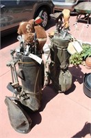two sets of old golf clubs