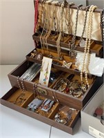 Brown jewelry box full of contents