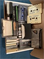 Box of cassette tapes including Proud to lLve in