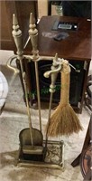 Vintage brass fireplace with three tools and a