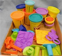Multiple containers of Play Doh with accessories