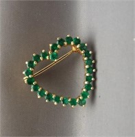 14K Yellow gold heart pin with green stones.