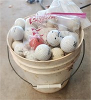 Golf balls a small bucket full