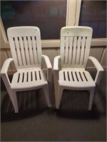 2 white resin chairs